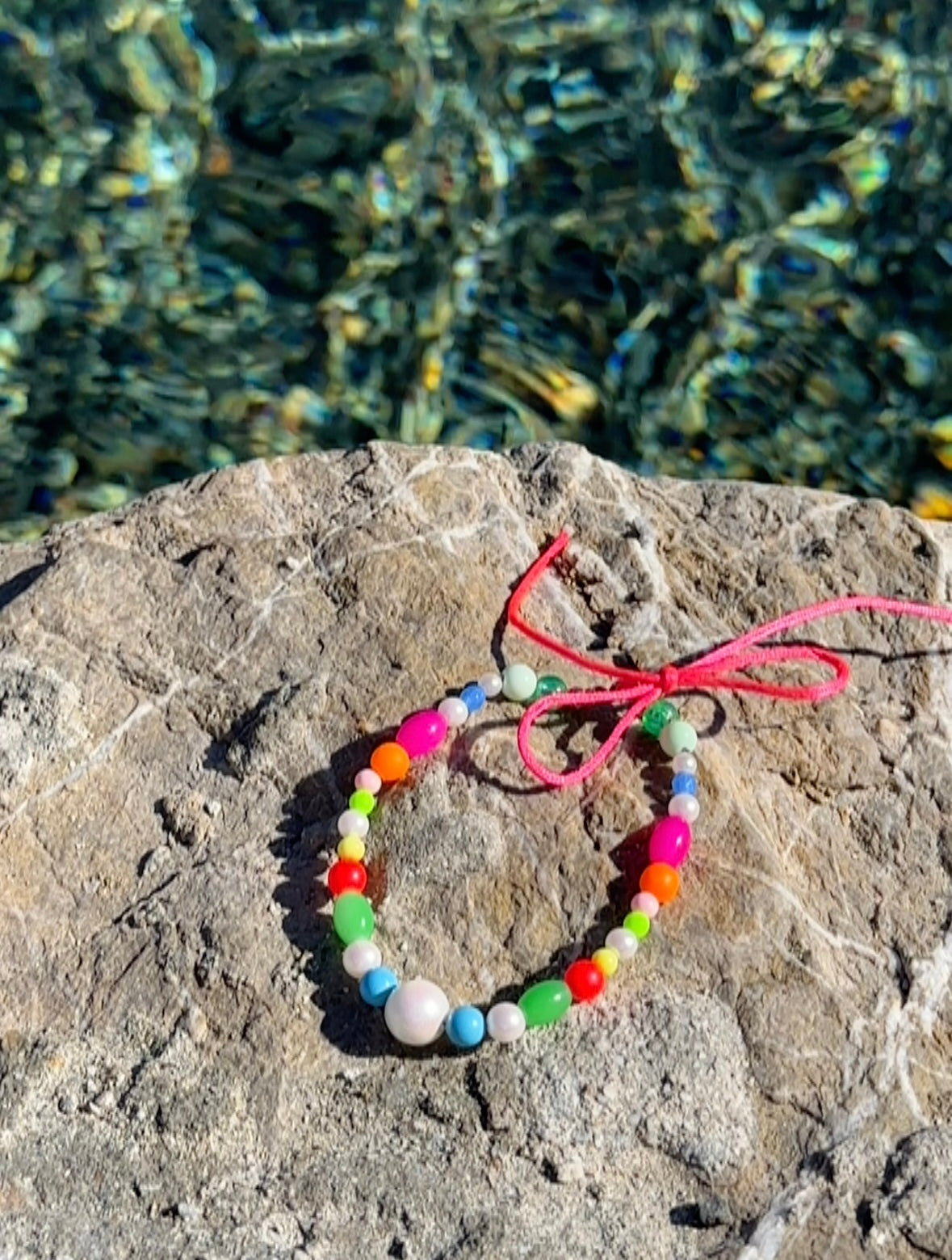 Multi coloured beaded anklet, pink silk tie
