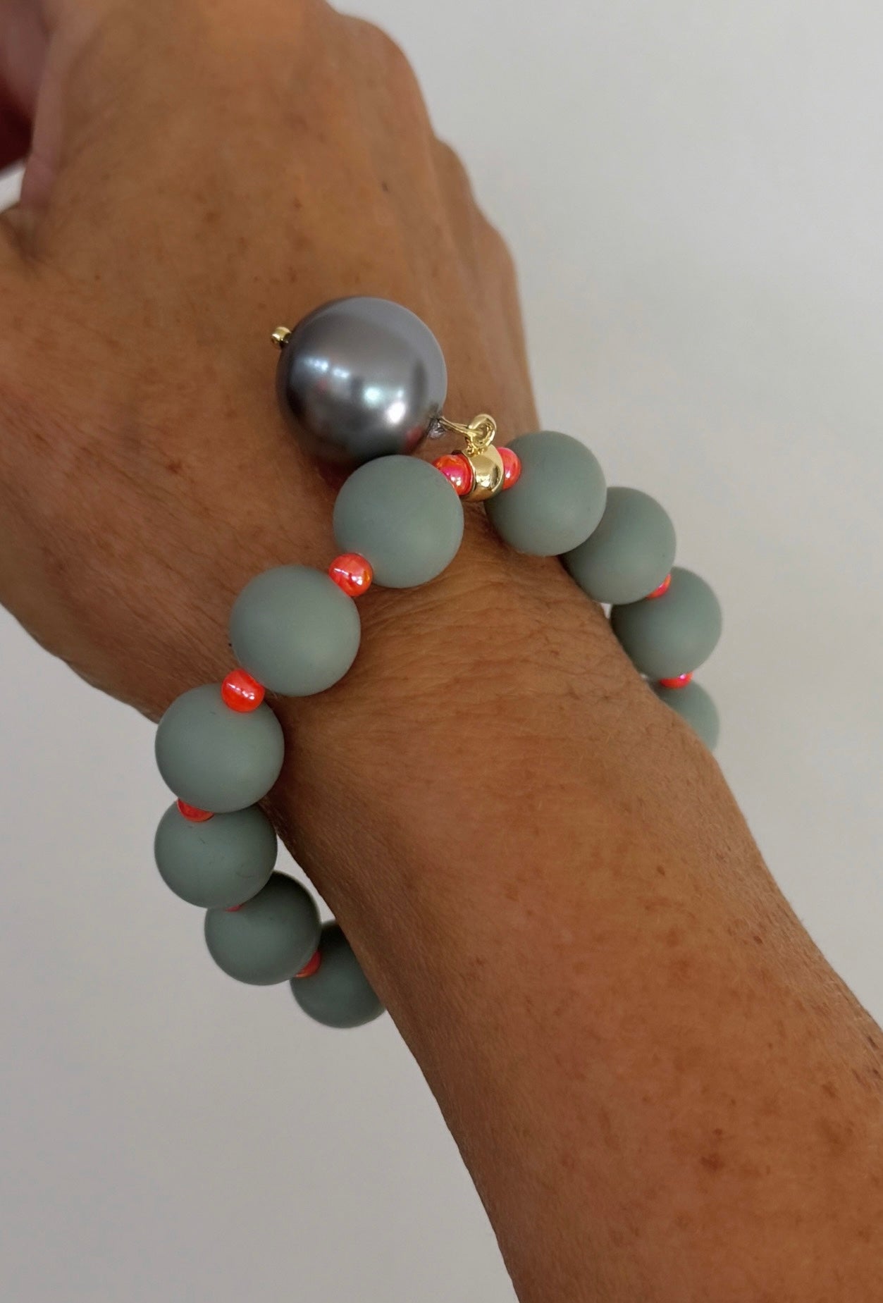 Beau green grey, orange + pearl charm bracelet