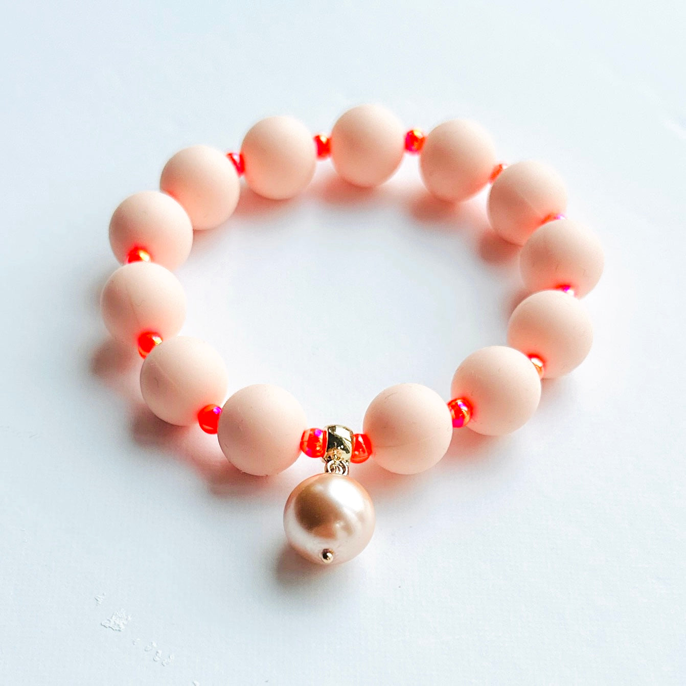 Beau peach + neon orange bracelet, pearl charm