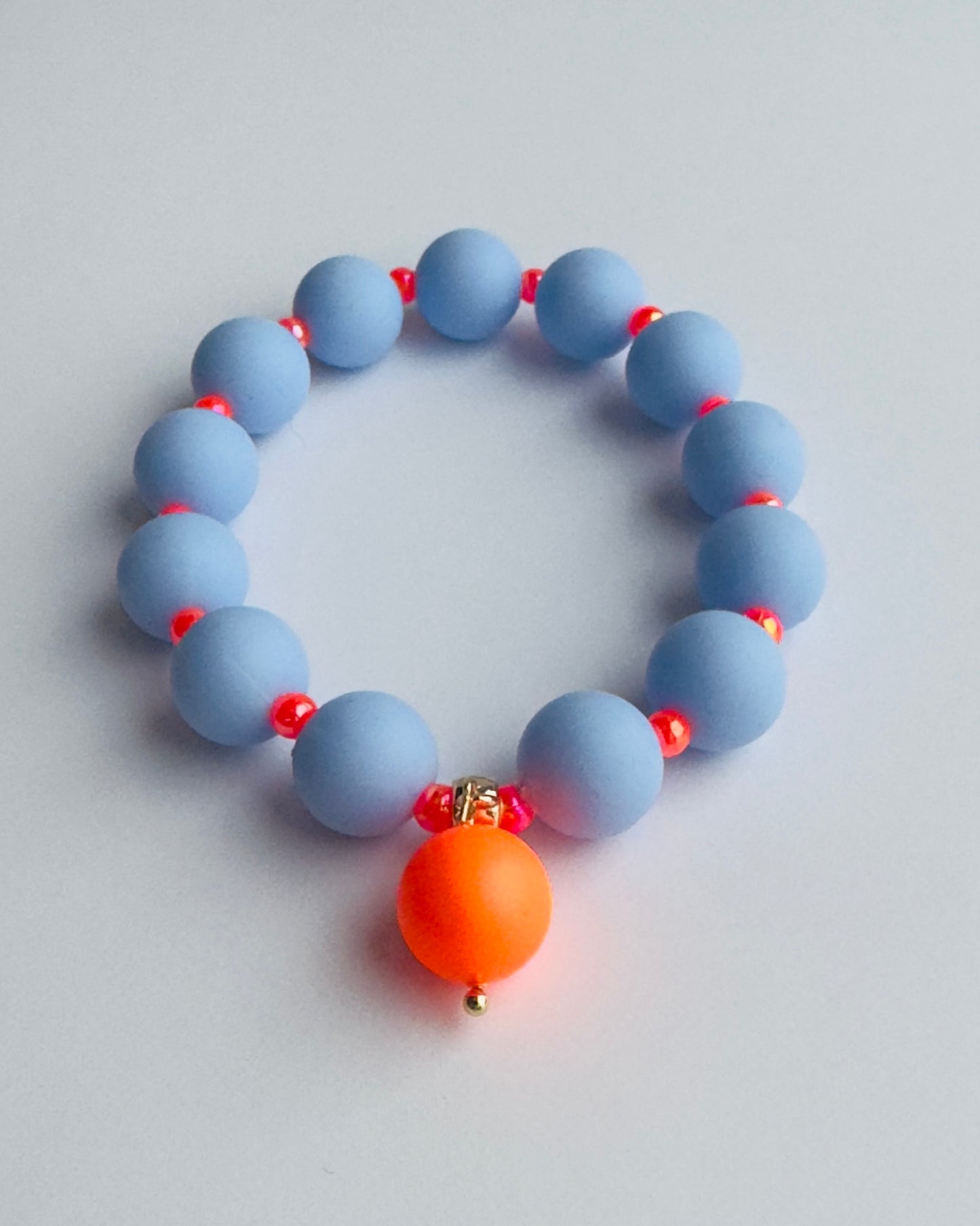 Beau bracelet in blue + neon orange, neon orange crystal pearl charm